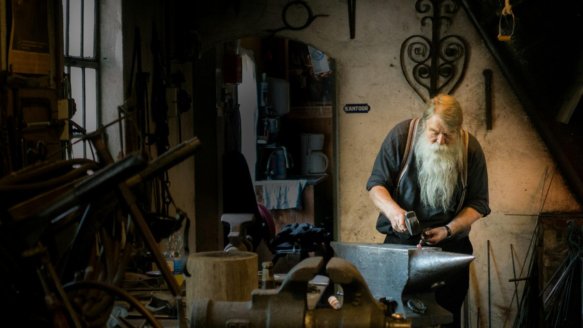 blacksmith holding mallet in garage